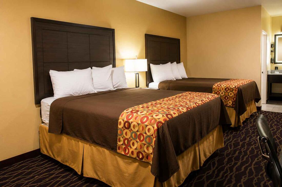 Deluxe Double room with two queen beds and warm lighting